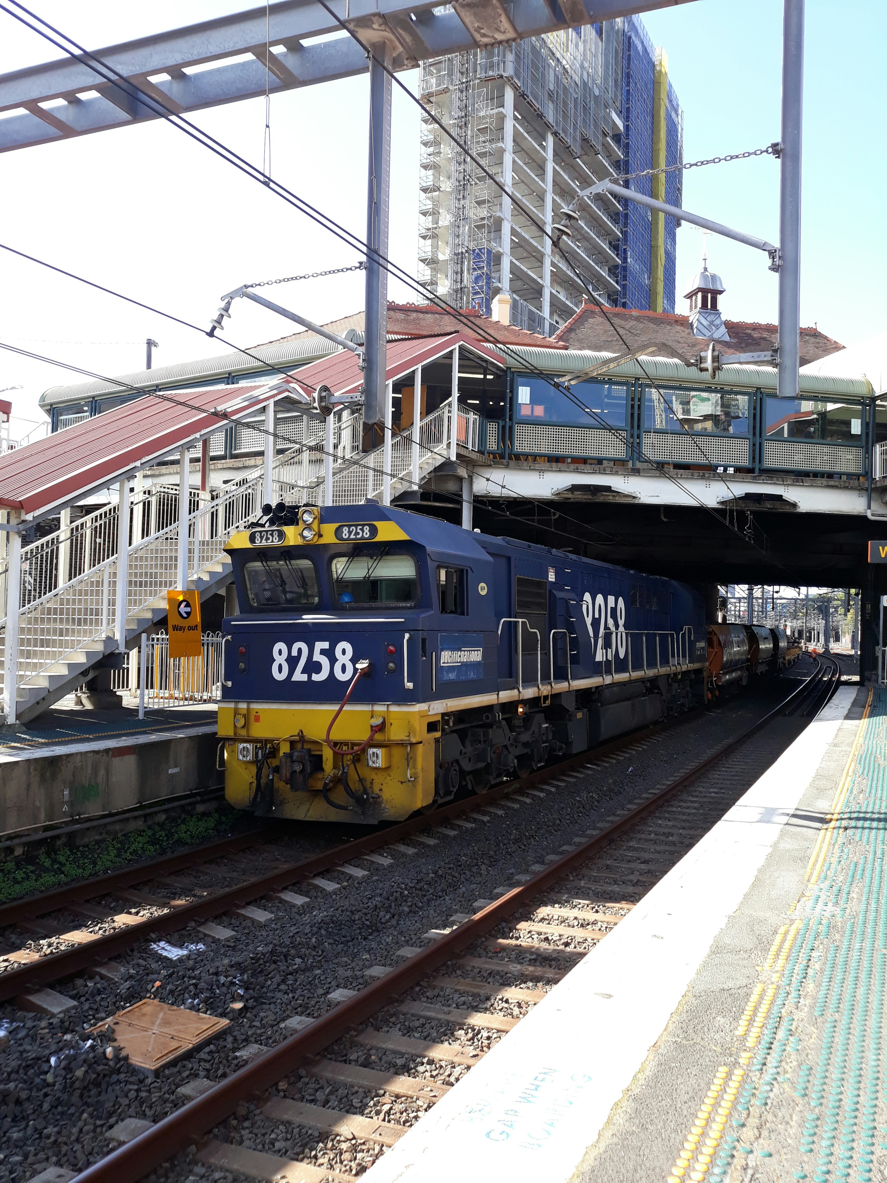 blue and yellow train on rail tracks