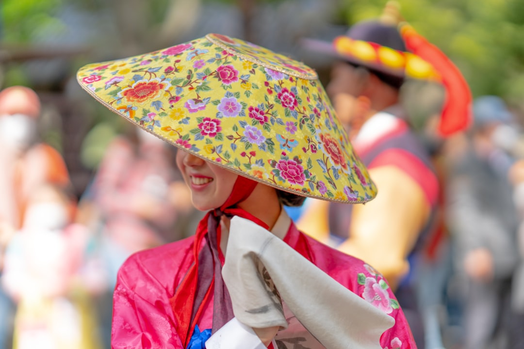 girl in red and white kimono holding floral umbrella