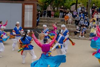 A vibrant traditional Korean festival with people in colorful hanbok dancing in the streets.