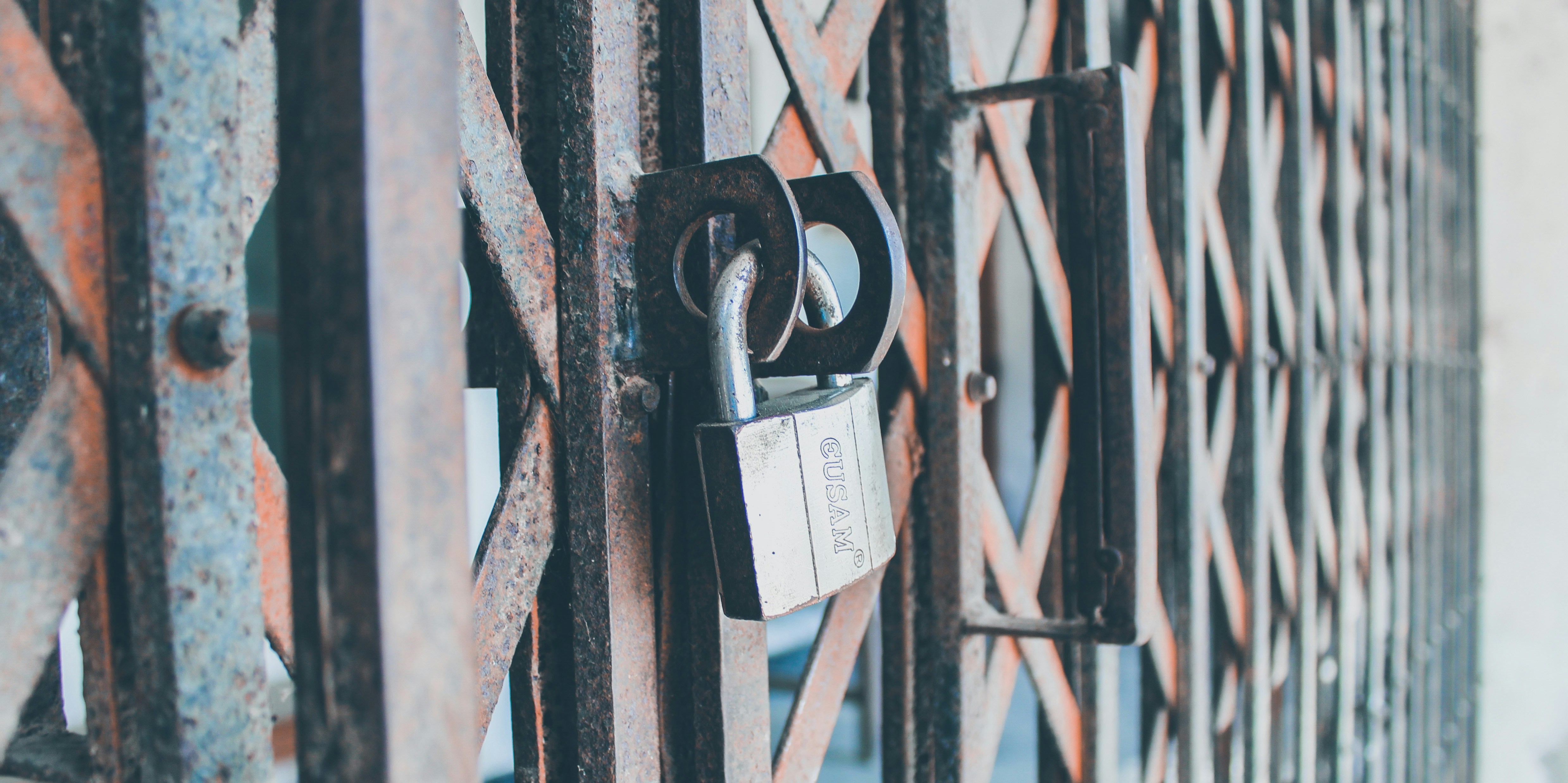 padlock on black metal fence