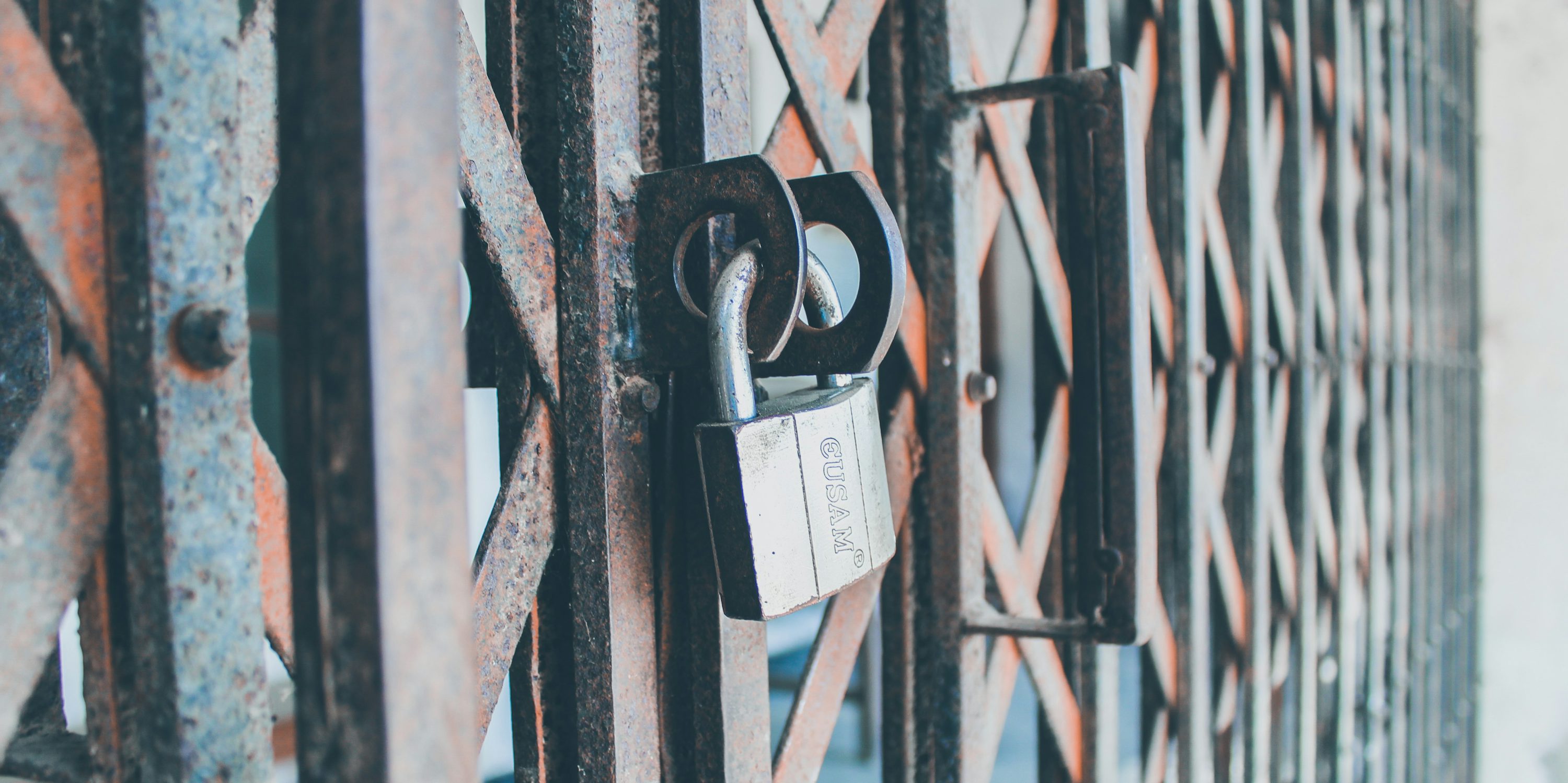 padlock on black metal fence