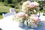 pink and white roses in white ceramic vase