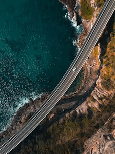 A taxi driving along the scenic coastal road of Portugal.