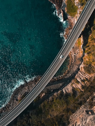 Rodrigues Mobility vehicle driving along a scenic coastal road near Angra dos Reis