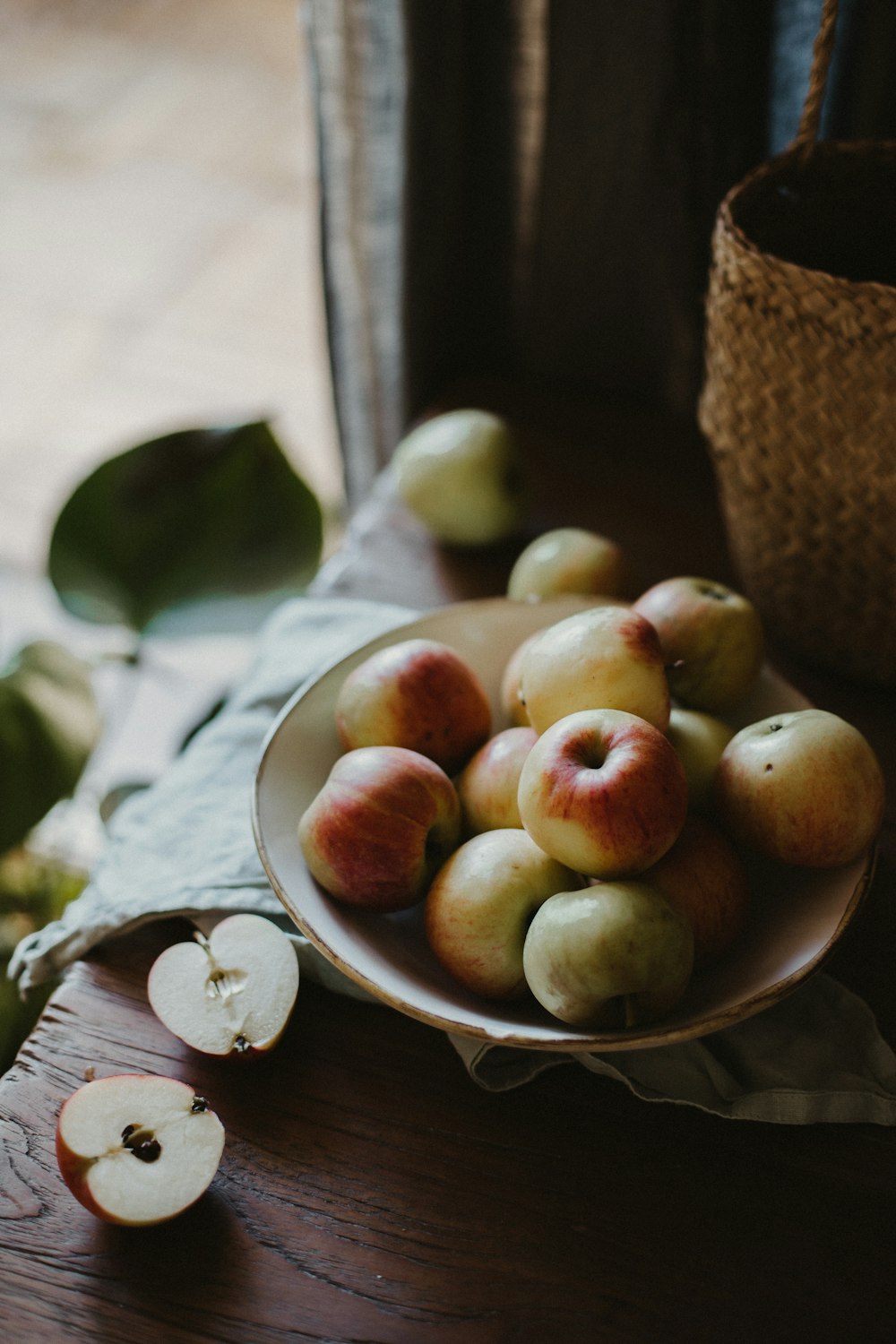 brown and green fruits on brown woven basket