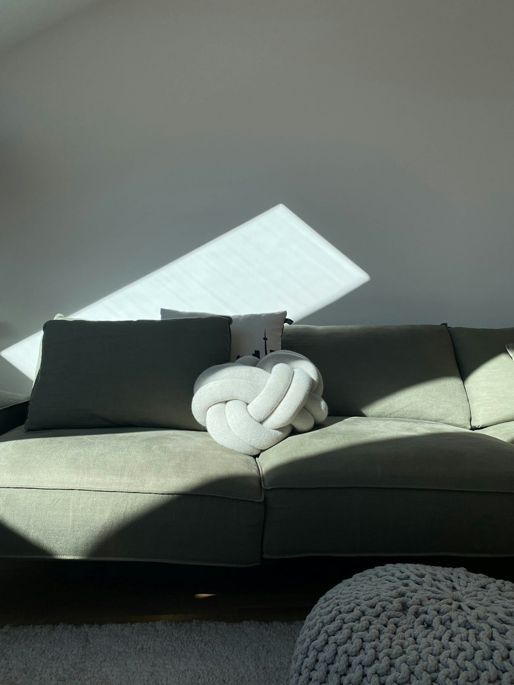 a couch with a blanket on top of it in a living room