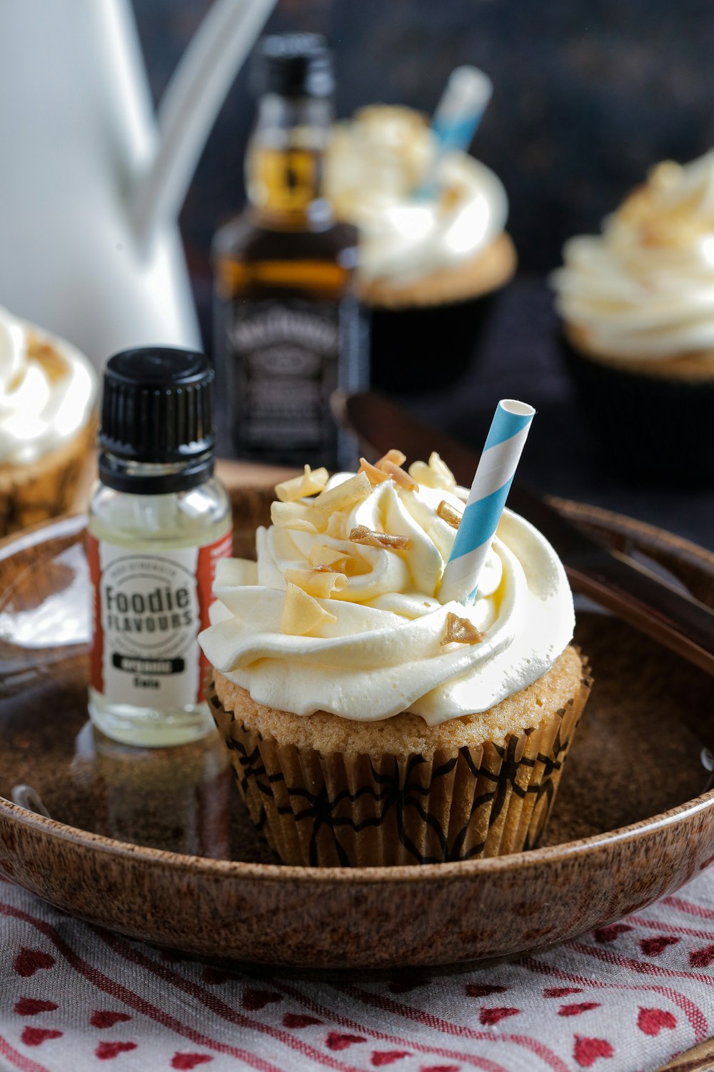 a cupcake sitting on top of a wooden plate