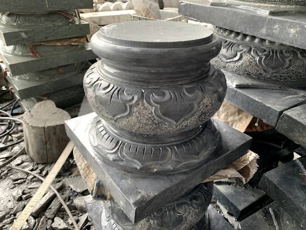 Polished ornamental stone blocks arranged in a sunlit workshop.