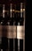 Several bottles of wine with the labels prominently displaying the name 'Markus Pfaffmann' and 'Grauburgunder 2019', arranged in a dimly lit environment.