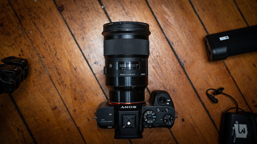 black nikon dslr camera on brown wooden table