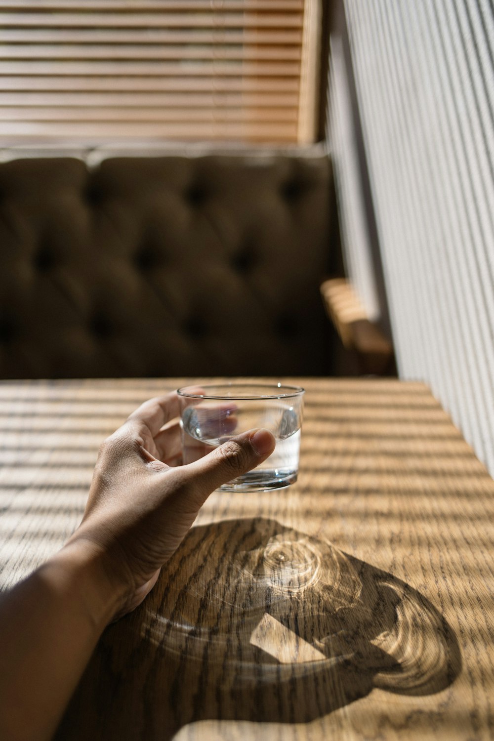 person holding clear drinking glass