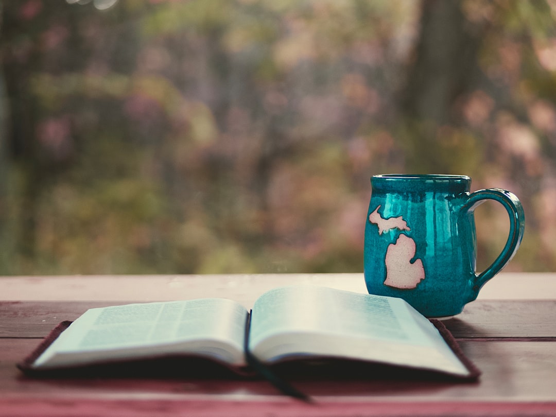 blue ceramic mug on book page