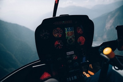 A pilot immersed in a helicopter flight simulator with six-axis motion platform and mixed reality visors.