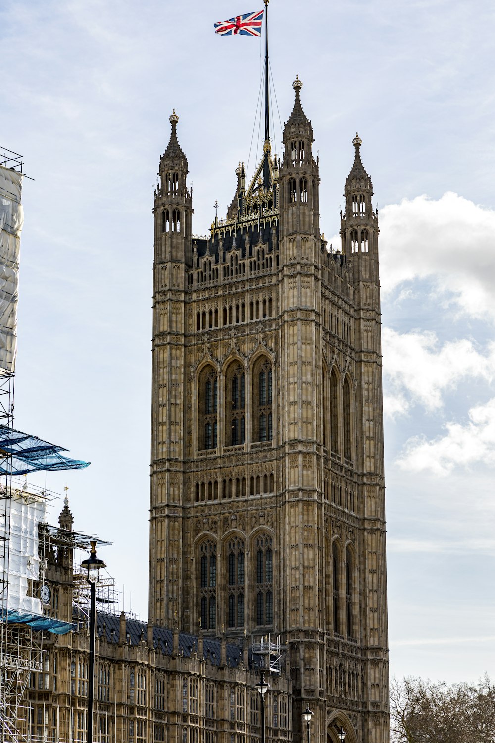 brown concrete building under white clouds during daytime