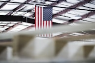 Indoor ceremonial flags arranged neatly in a well-lit showroom.