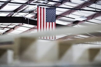 Indoor ceremonial flags arranged neatly in a well-lit showroom.