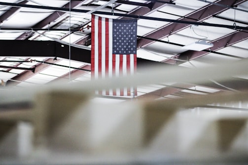 Hyperbaric oxygen therapy chamber ready for clients, set against a backdrop of a subtle American flag displayed on the wall.