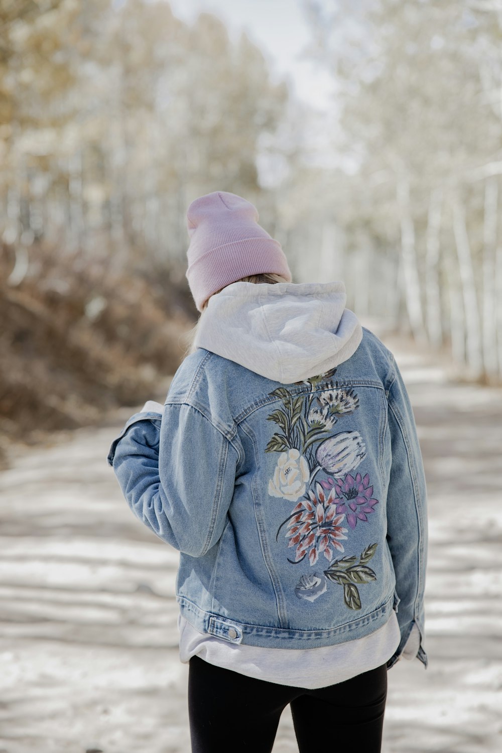 person in blue jacket and pink knit cap