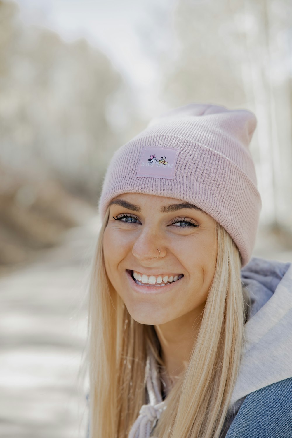 smiling woman in gray knit cap