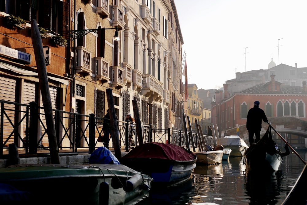 boat on river between buildings during daytime