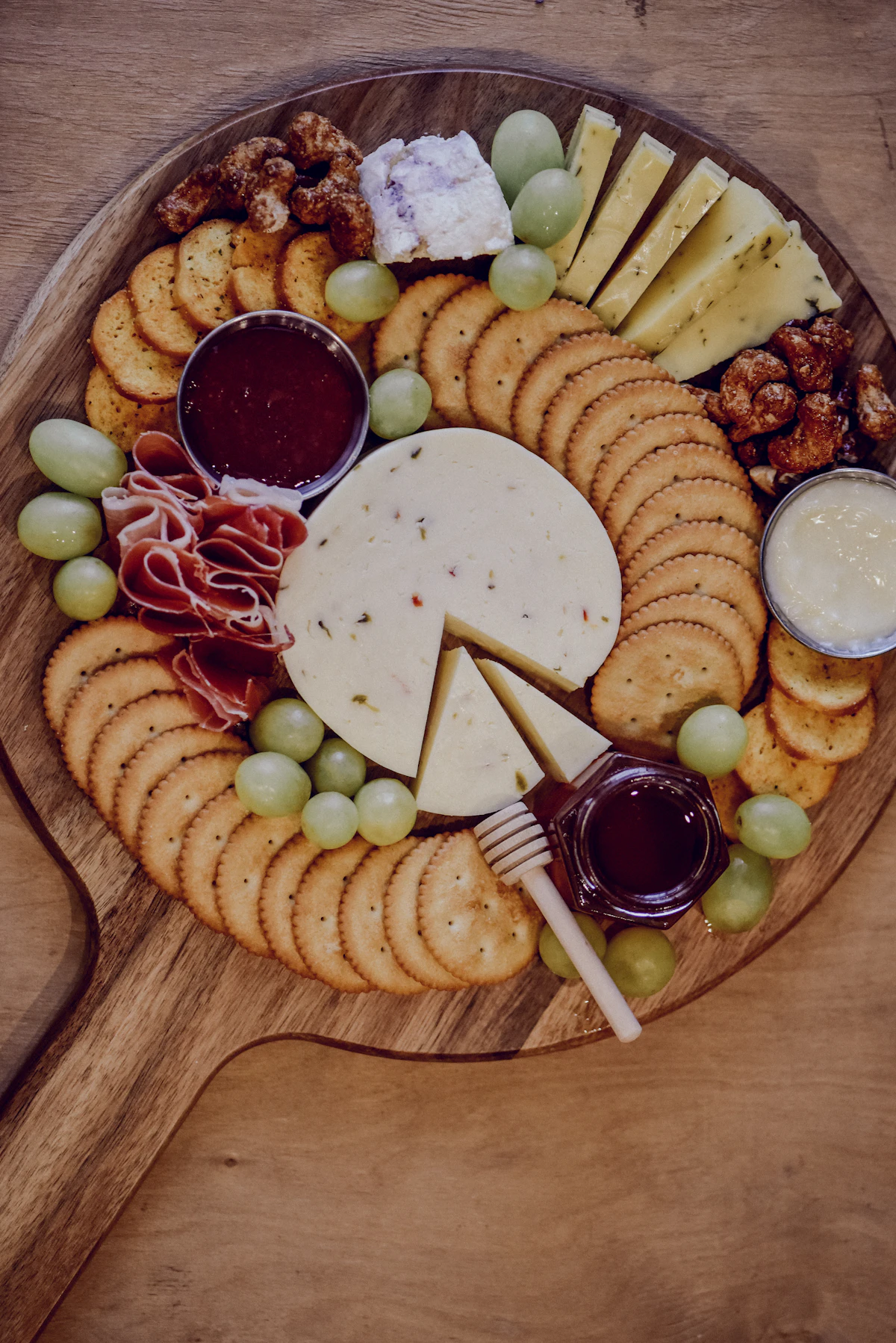 Large spread comparing a charcuterie board and cheese board side by side for a crowd