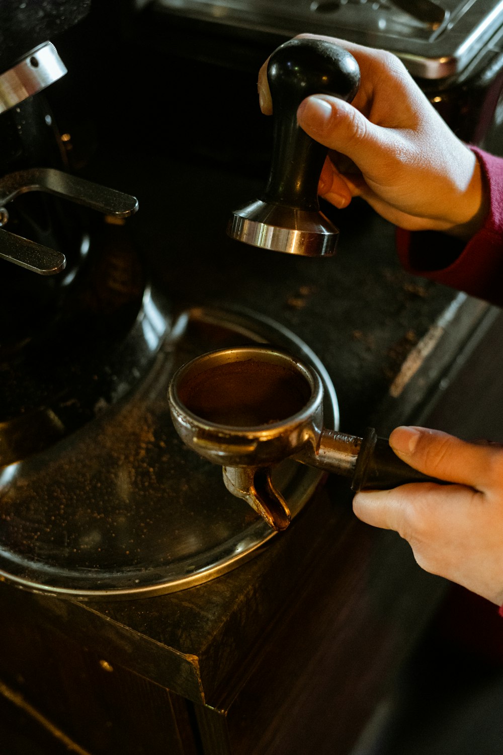 person holding brass steel cup