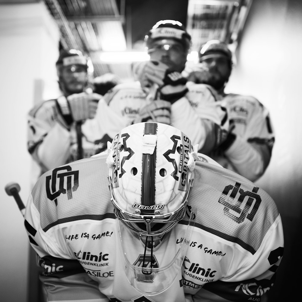 grayscale photo of football players