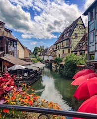 red umbrella on river near houses