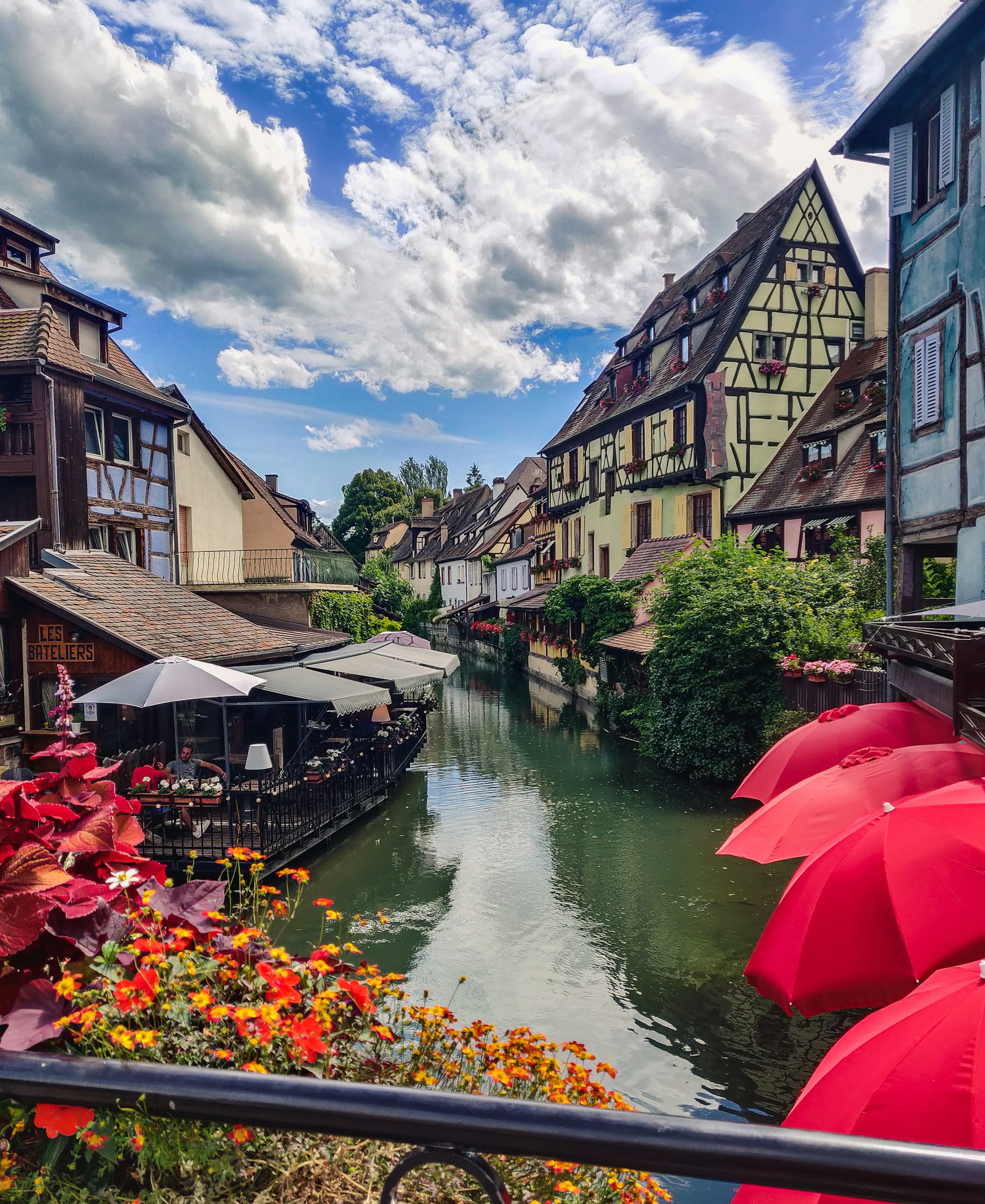 red umbrella on river near houses