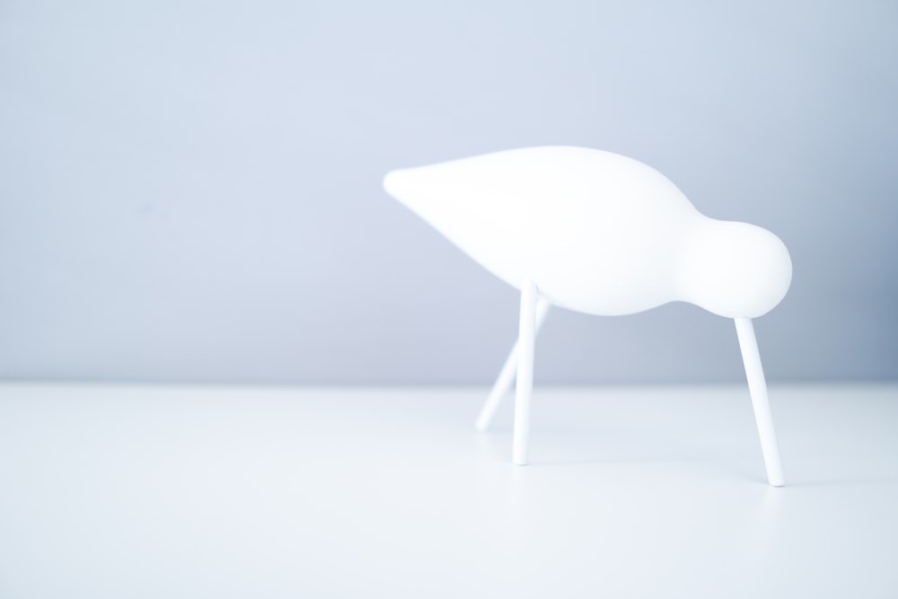 white plastic chair on white surface