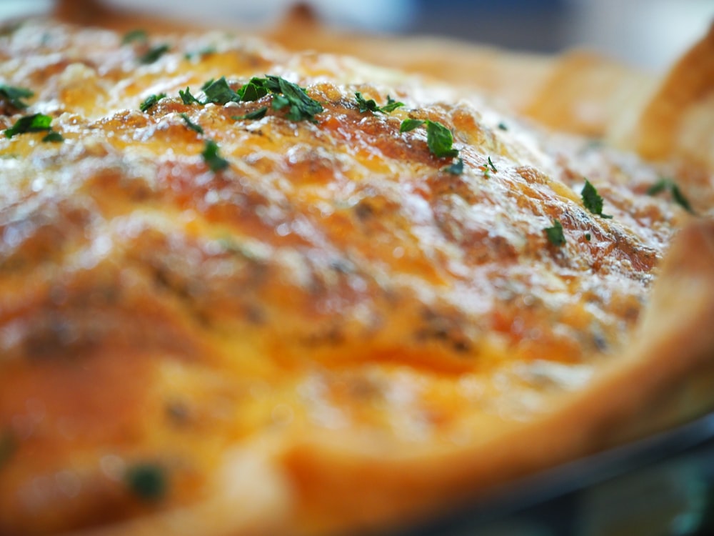 brown and white pizza on brown wooden table