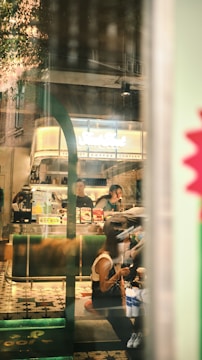 A vibrant coffee shop interior with customers enjoying their drinks.