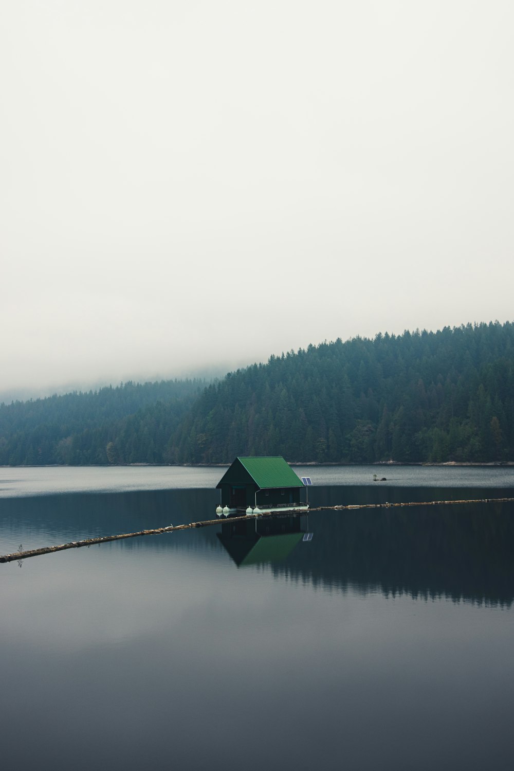 green and black house on lake during daytime