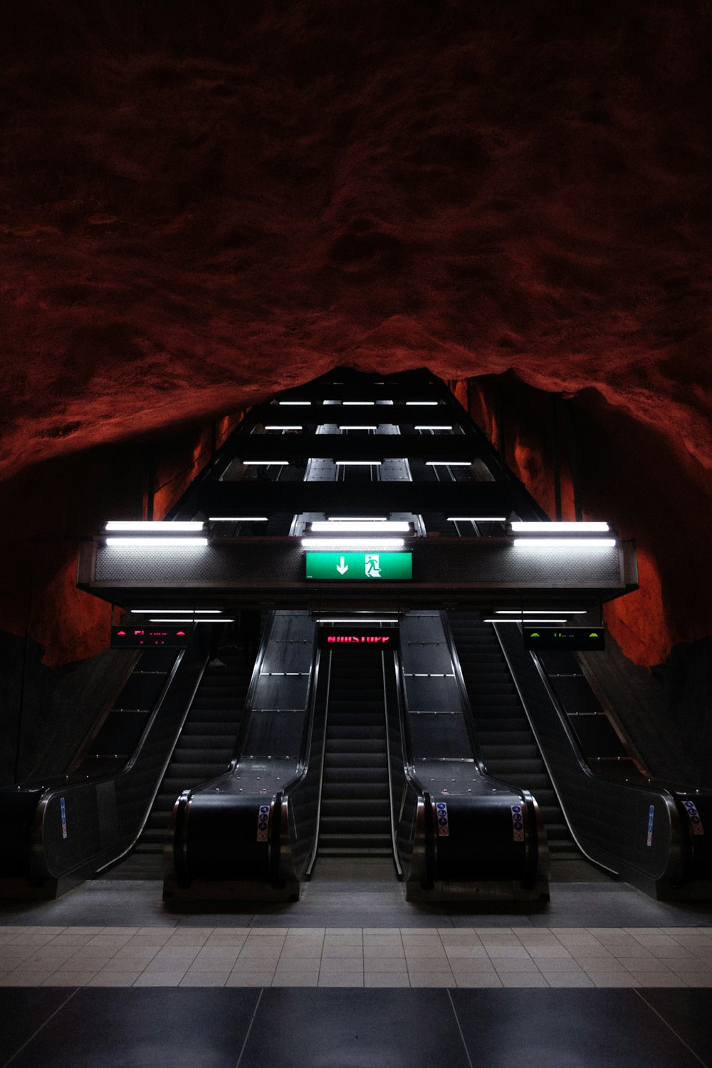 black and silver escalator on brown wooden floor