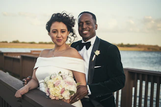 man in black suit jacket holding bouquet of flowers