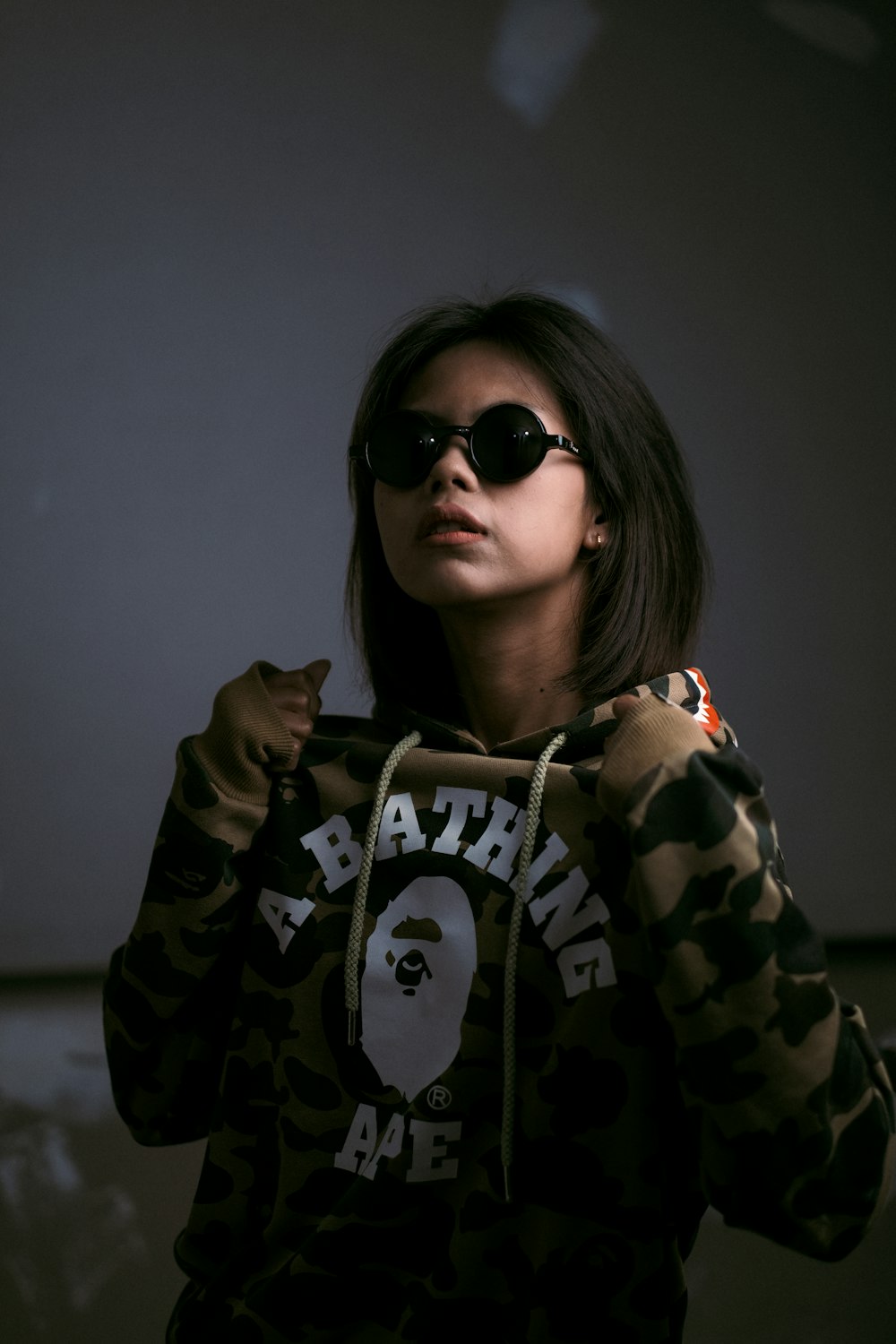 woman in black and white hoodie wearing black sunglasses