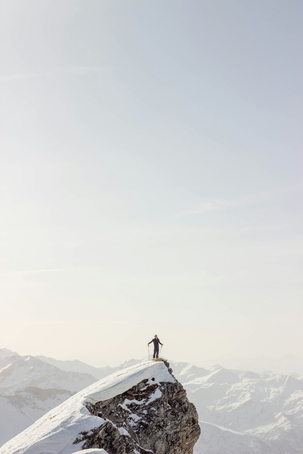 person standing on top of mountain during daytime