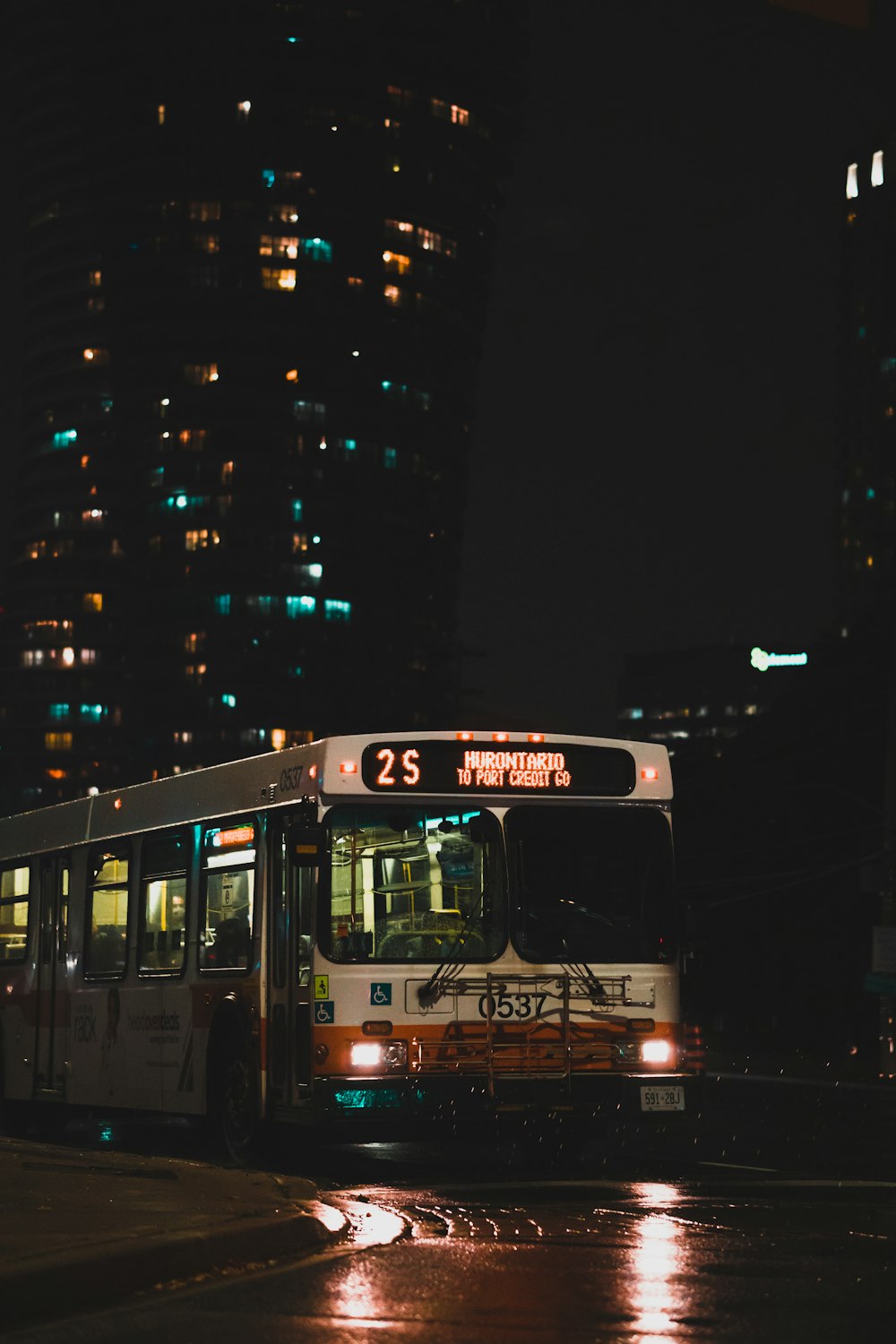 red and white bus on road during night time