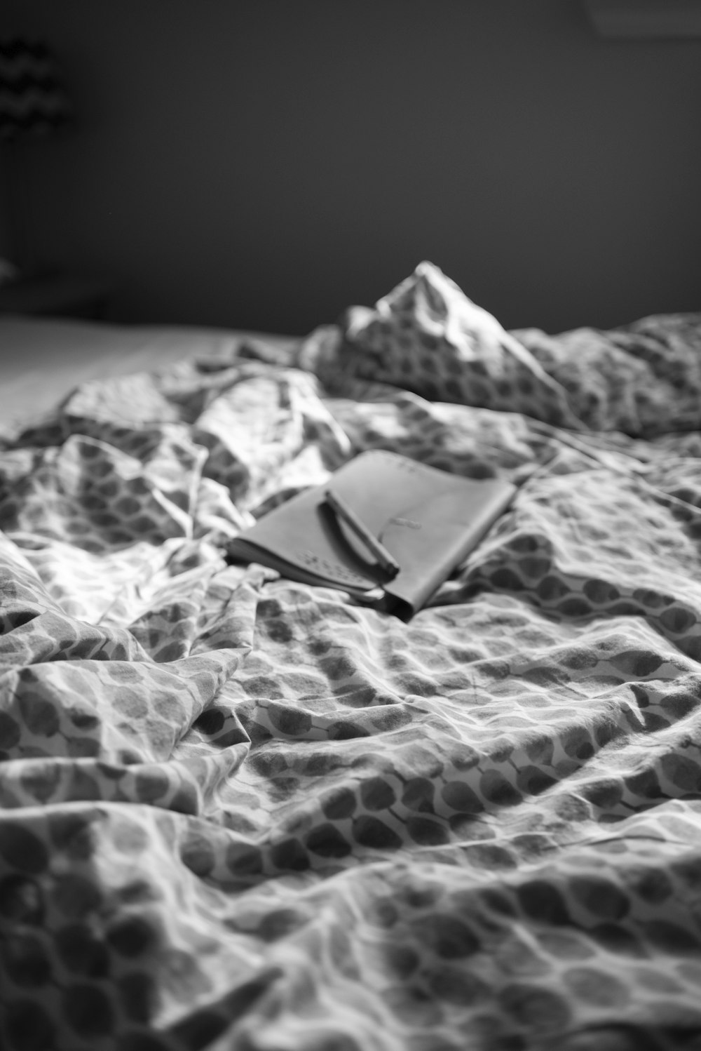 black and white photo of a smartphone on a white and black textile