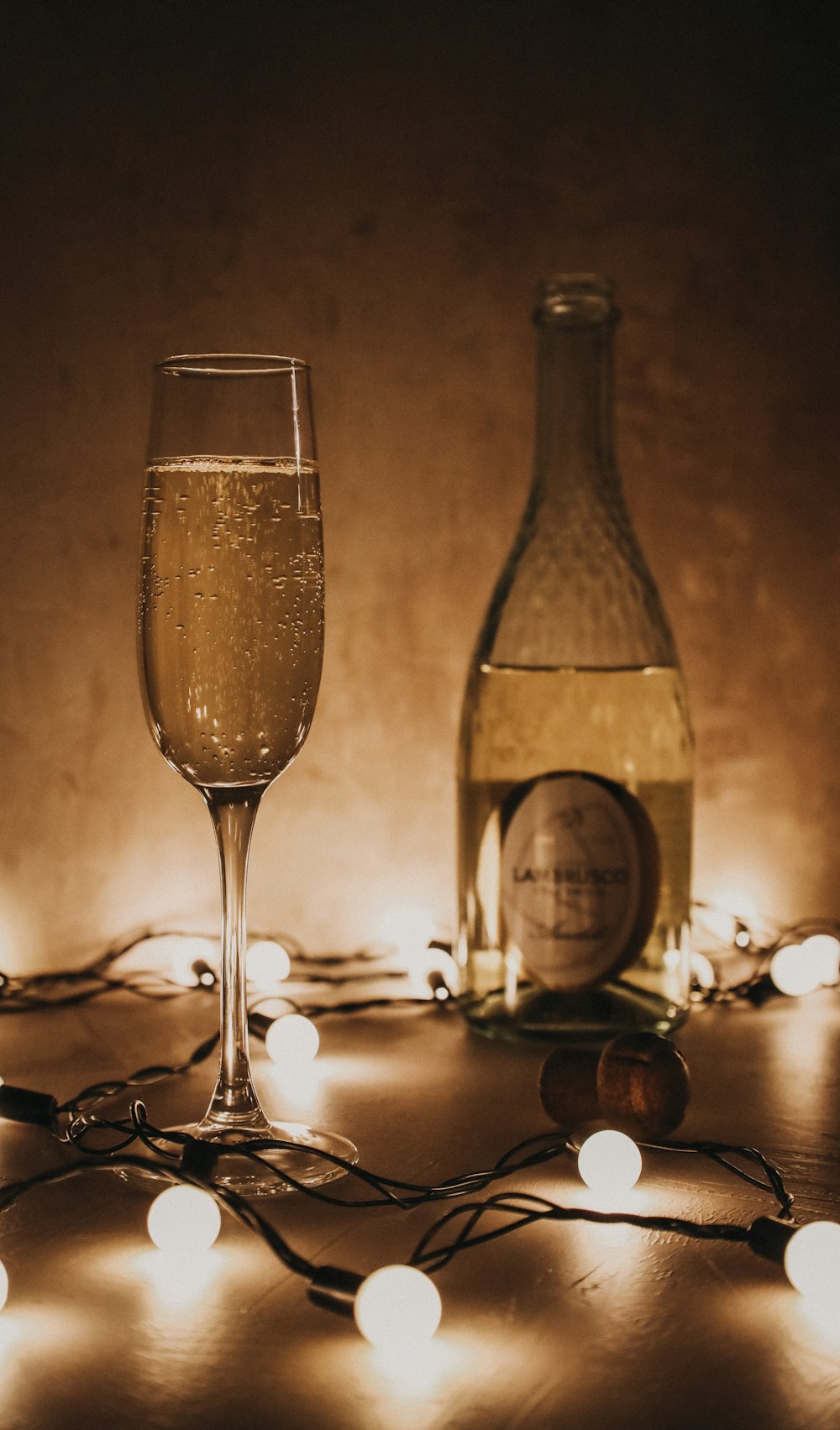 clear wine glass beside wine bottle