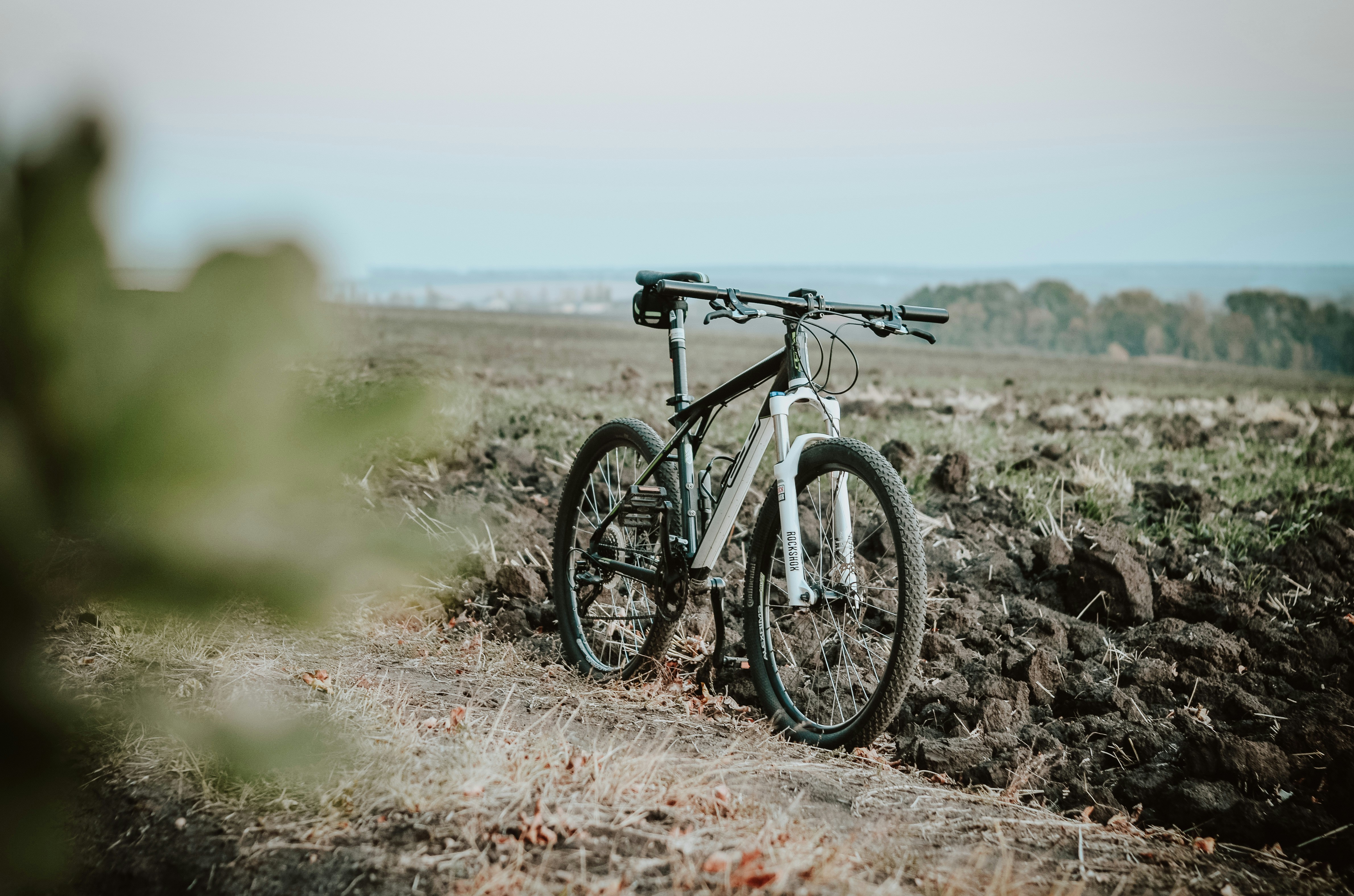 black and white mountain bike on brown field during daytime