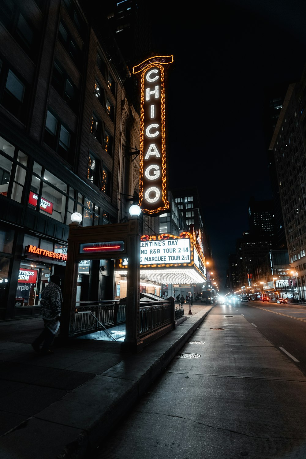 people walking on sidewalk during night time