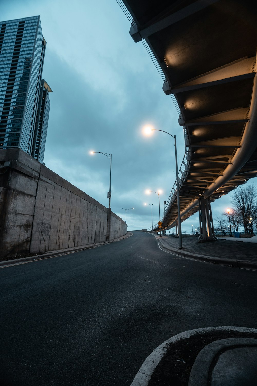 empty road between high rise buildings during daytime