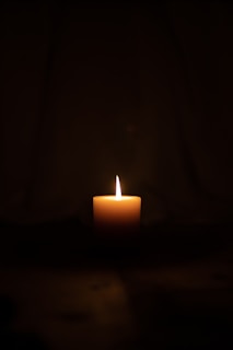 lighted citronella candle in dark room