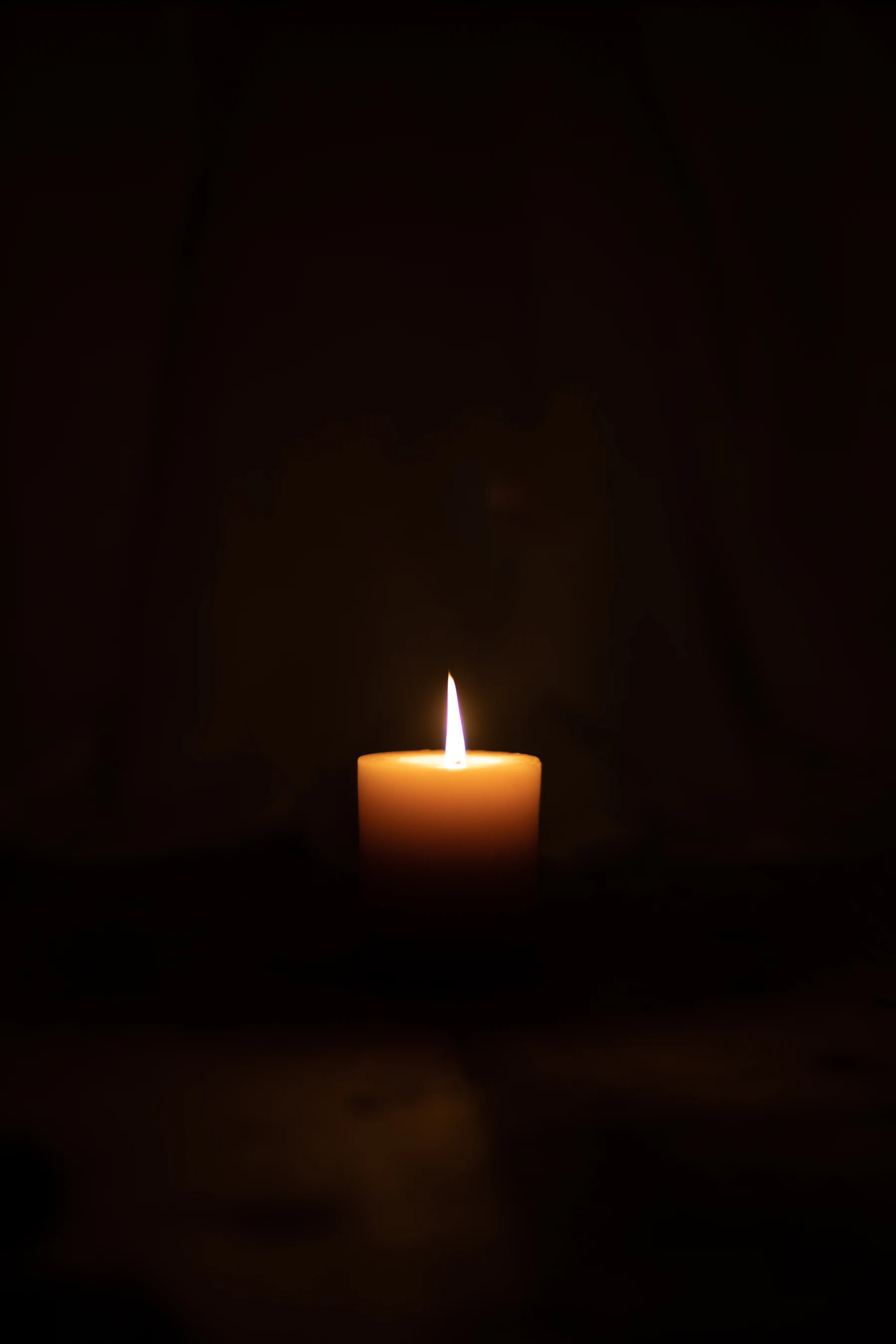 Candlelight in a darkened ceremony space