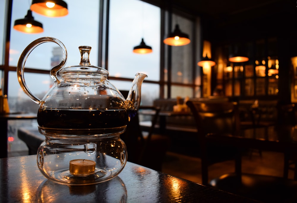 stainless steel teapot on table