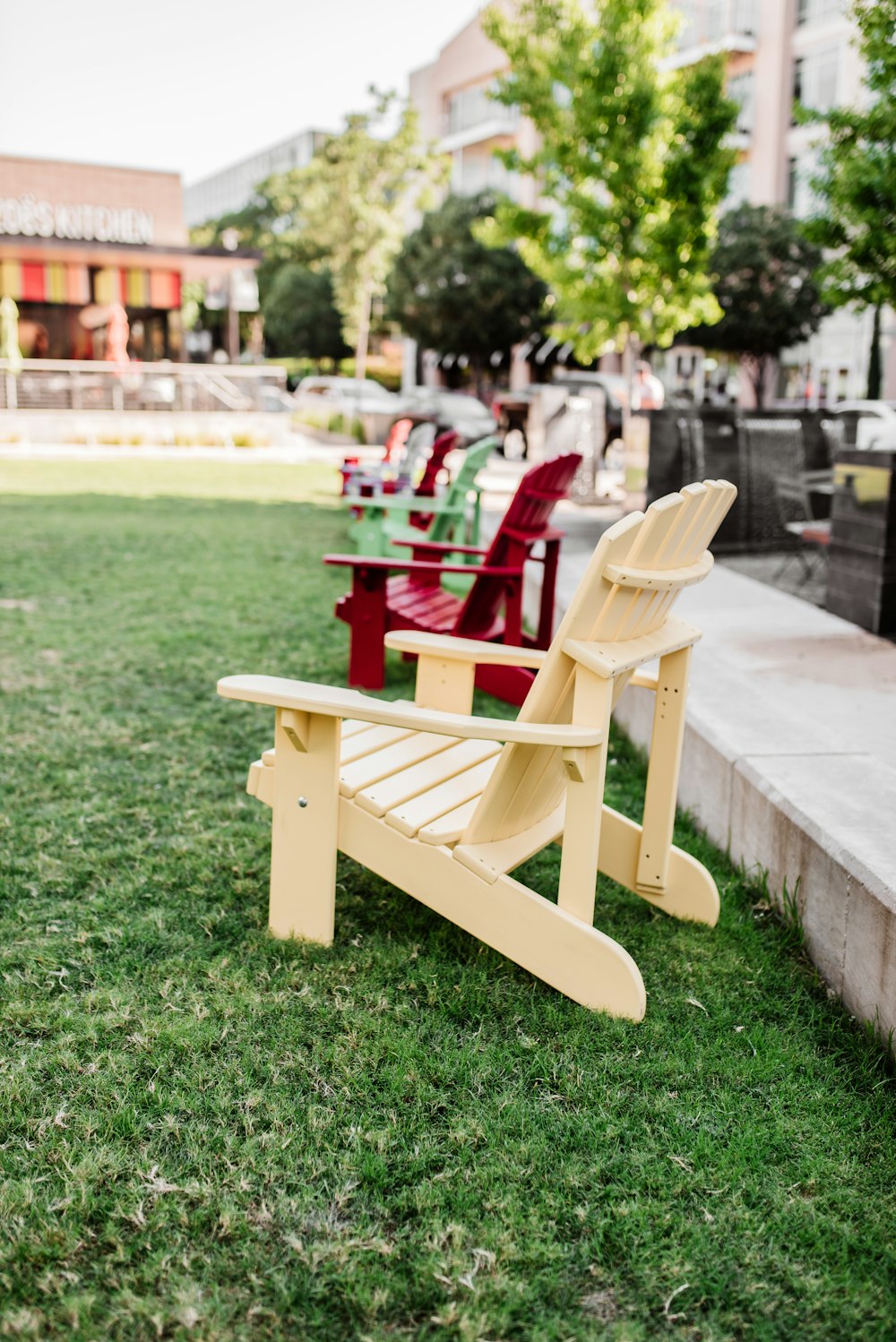 brown wooden armchair on green grass field during daytime