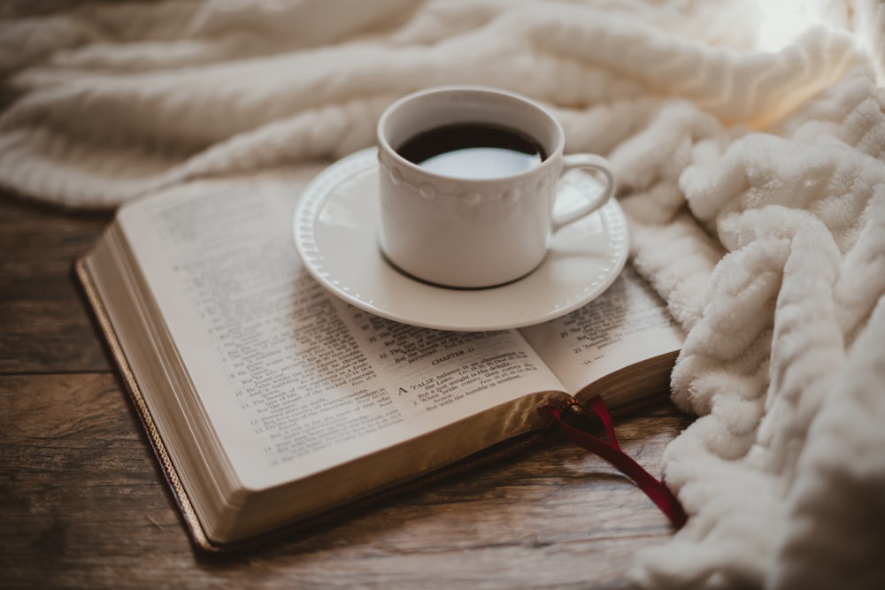 Tasse en céramique blanche sur soucoupe en céramique blanche