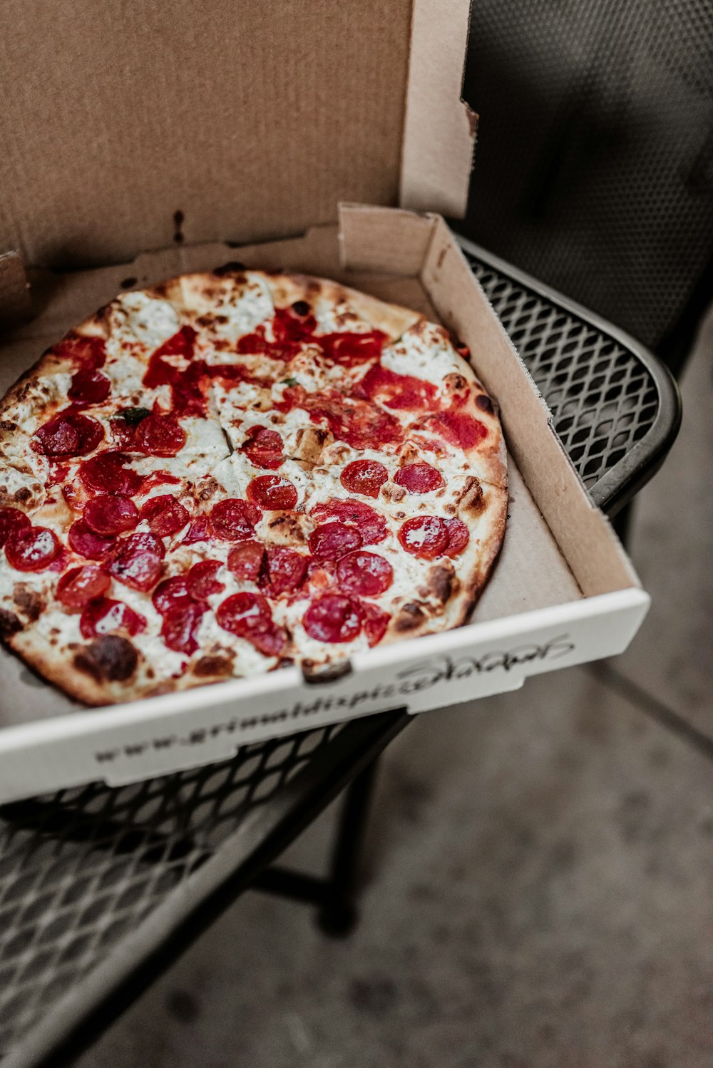 pizza on brown wooden box