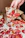 Close-up of a happy customer enjoying a slice of thin-crust New York style pizza at Pirata's Pizza.